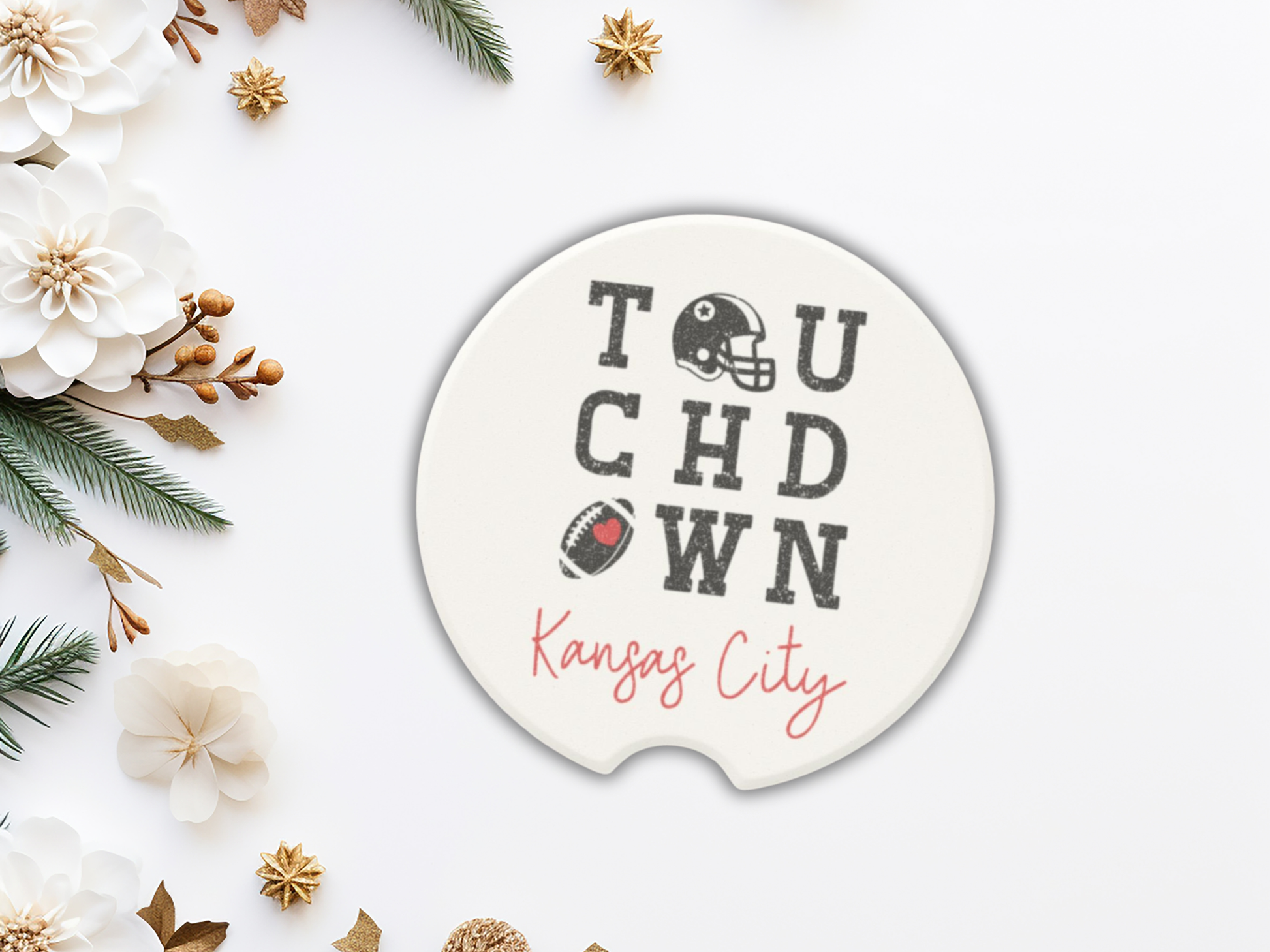 Circular decorative item with 'Touchdown Kansas City' text, surrounded by flowers and greenery on a white background