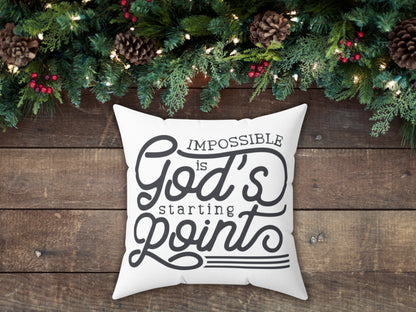 Decorative pillow with motivational quote on a wooden surface with Christmas decorations.
