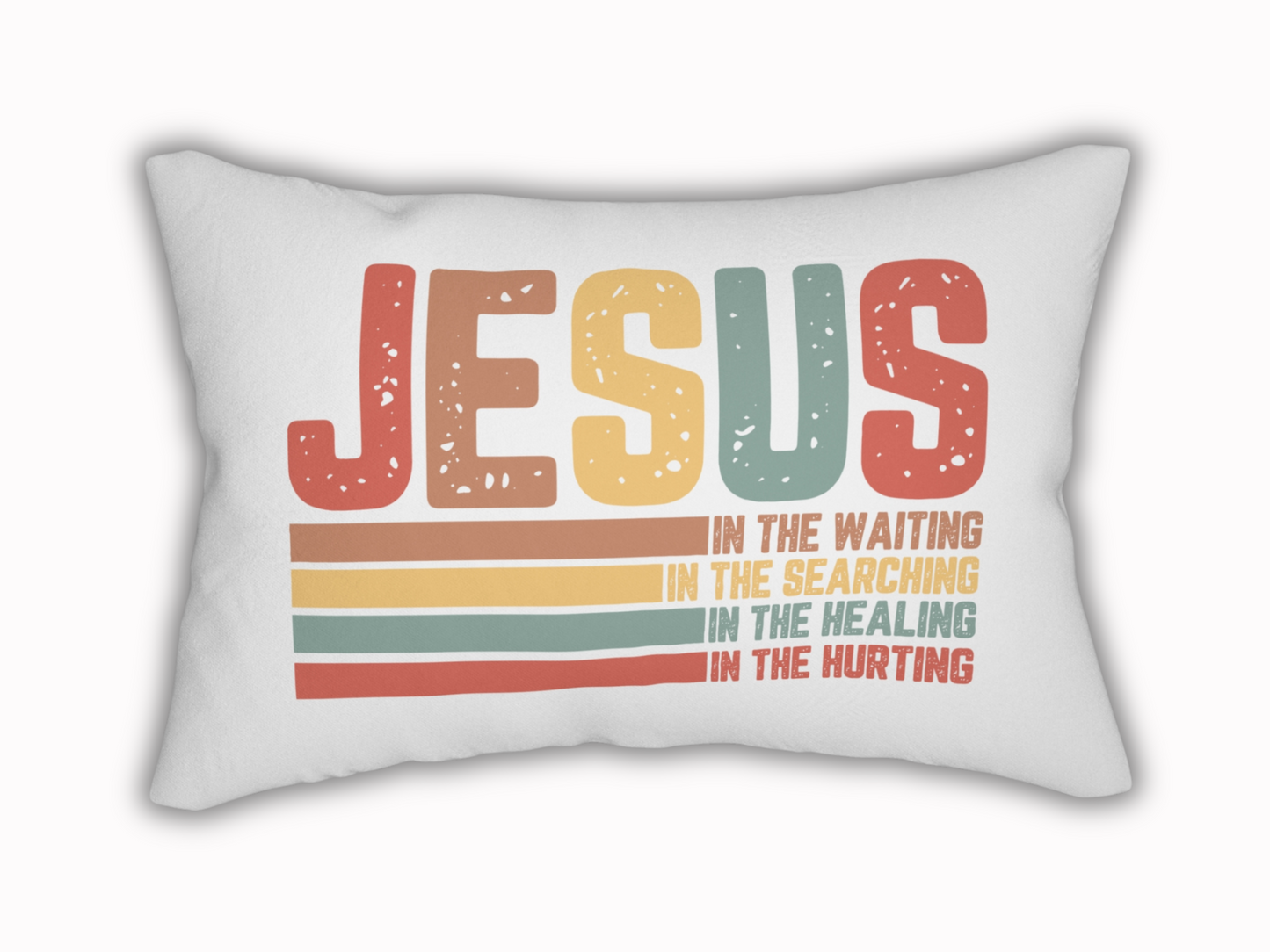 White lumbar pillow on plain background featuring “JESUS In the Waiting, In the Searching, In the Healing, In the Hurting” design.