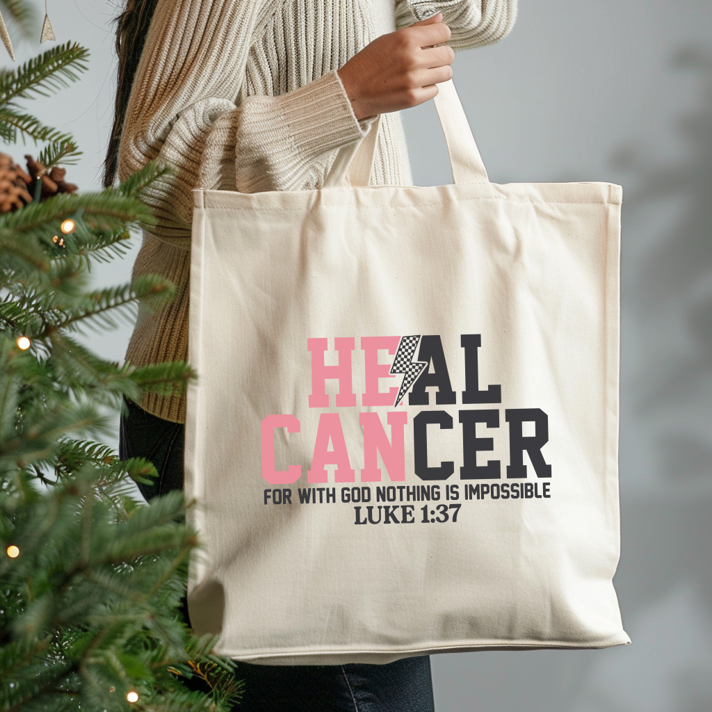 Tote bag with 'HEAL CANCER' text held by a person next to a Christmas tree.