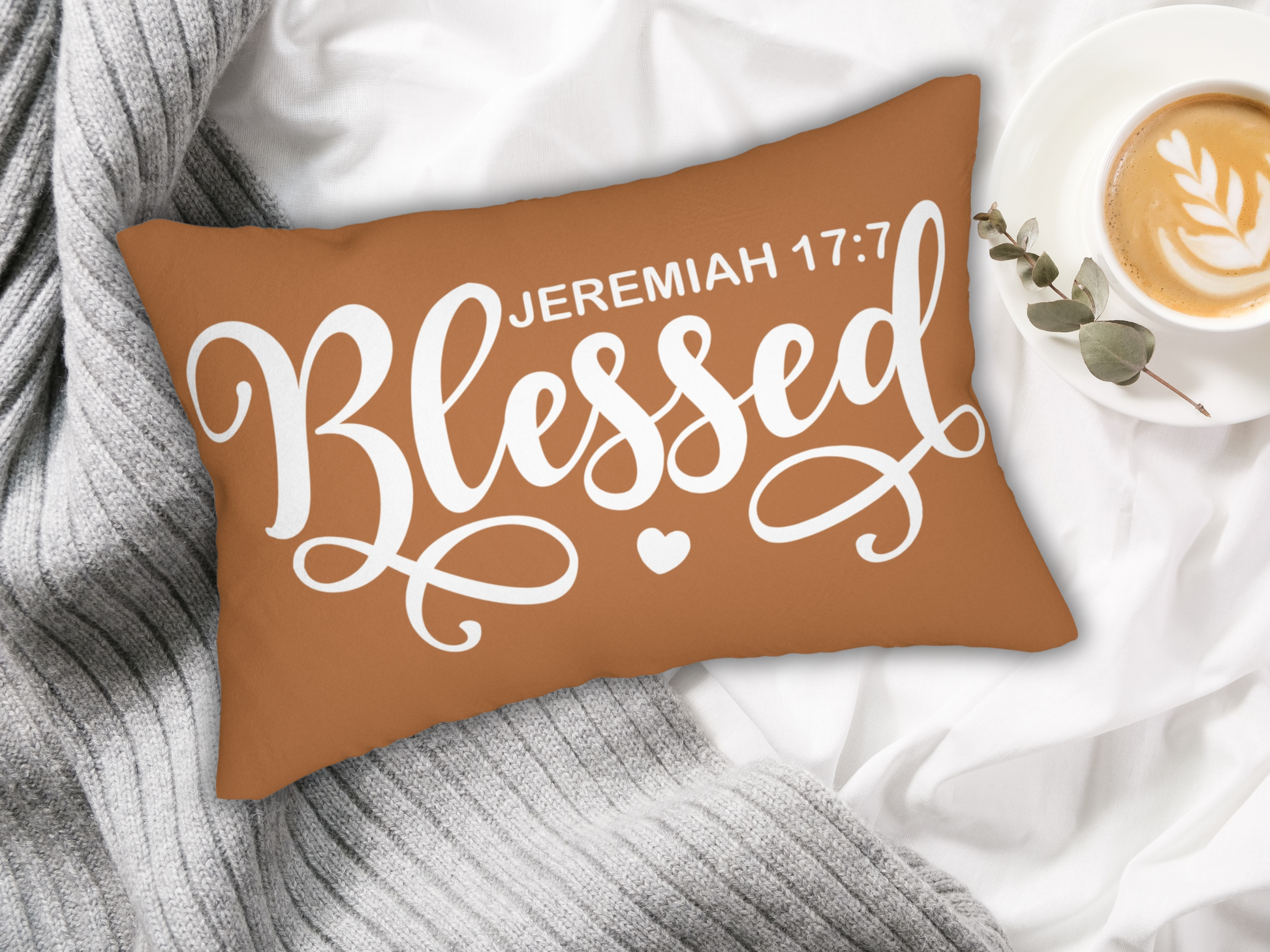 “Blessed” pillow styled with a gray knit throw and latte in a white cup, adding warmth to bedding.