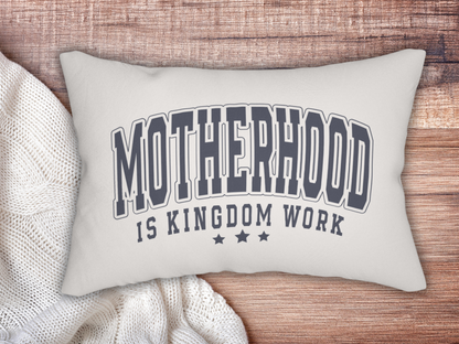 Christian motherhood pillow styled on a wooden surface with a cozy white knit blanket.