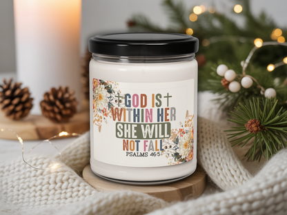 Candle jar with motivational quote on a cozy background with lights and pine cones