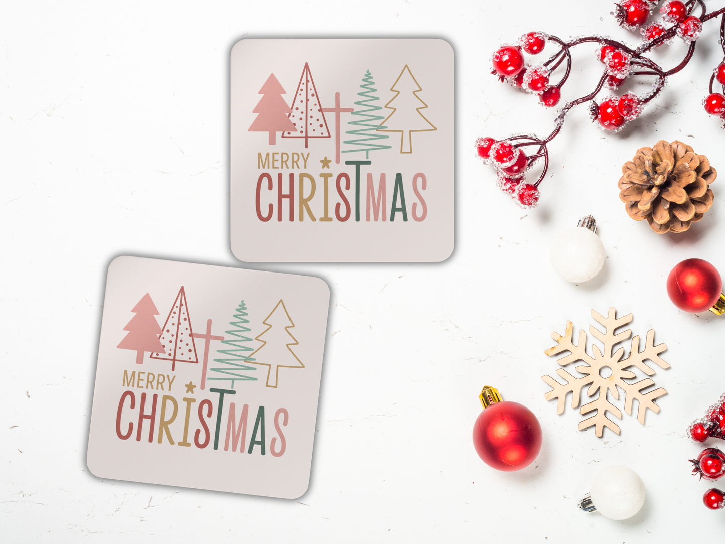 Two 'Merry Christmas' coasters with decorative elements on a white background