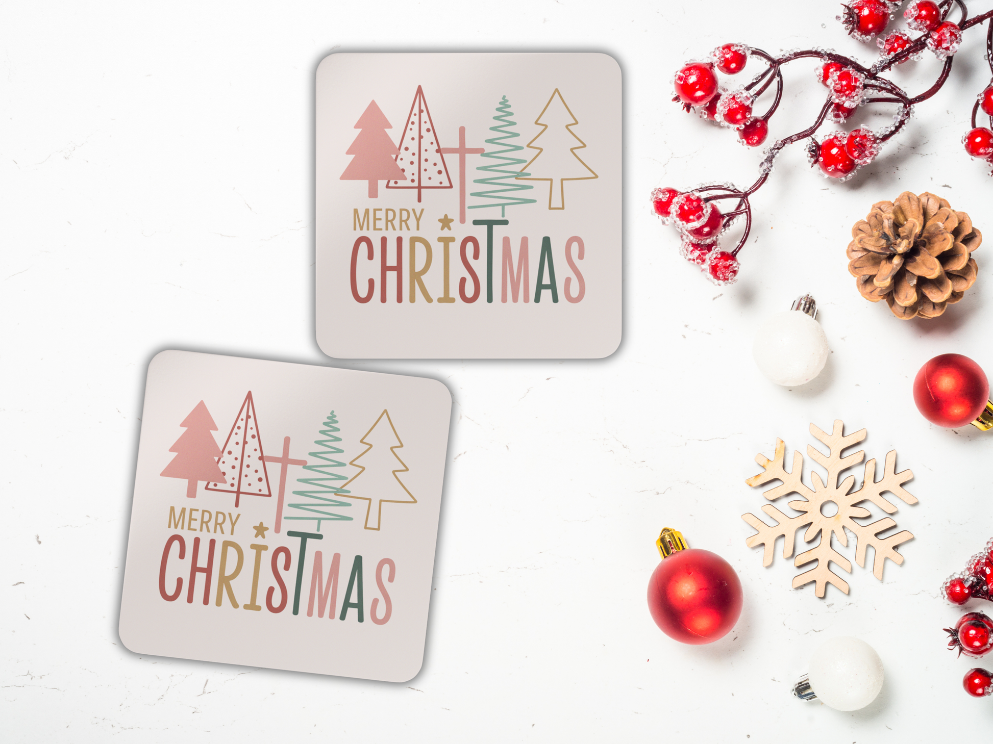 Two 'Merry Christmas' coasters with decorative elements on a white background