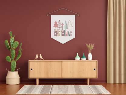 Decorative wall art hanging with 'Merry Christmas' text in a room with a wooden cabinet, plants, and a red wall.