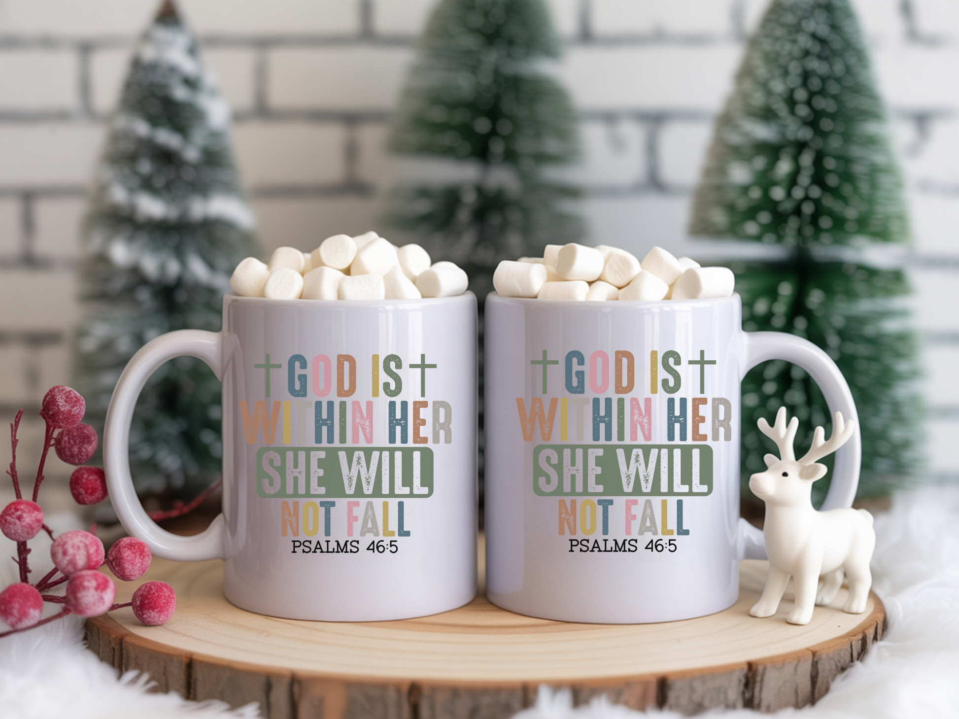 Two mugs with text and hot chocolate on a wooden stand with Christmas decorations.