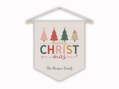 Decorative banner with Christmas trees and 'Merry Christmas' text on a soft pink background