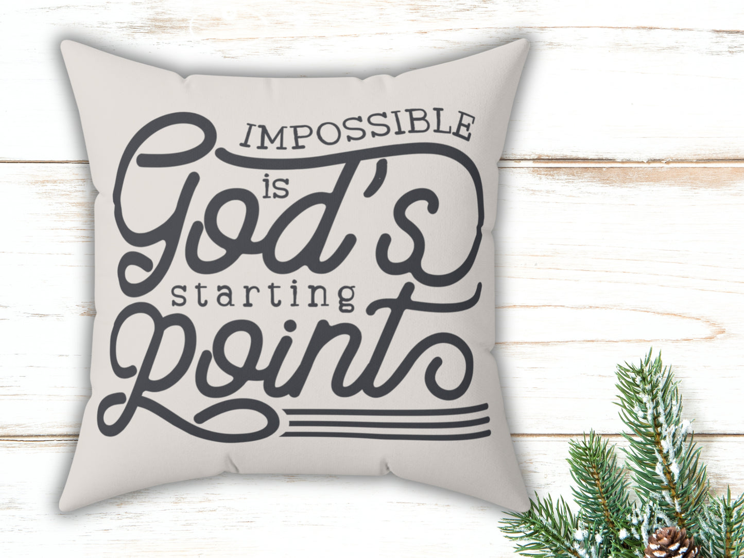Decorative pillow with motivational quote on a wooden surface with Christmas decorations.