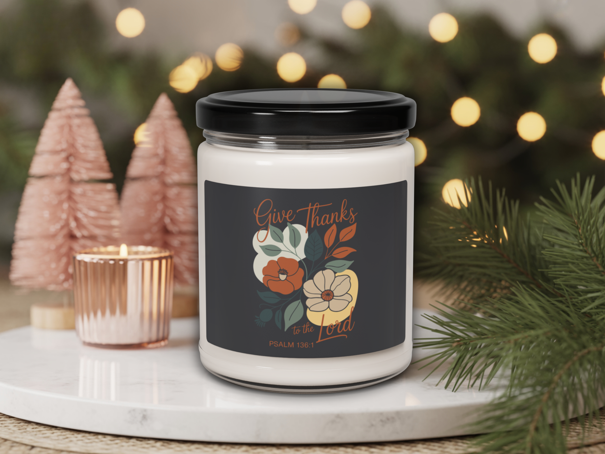 Candle jar with decorative label on a table with Christmas decorations
