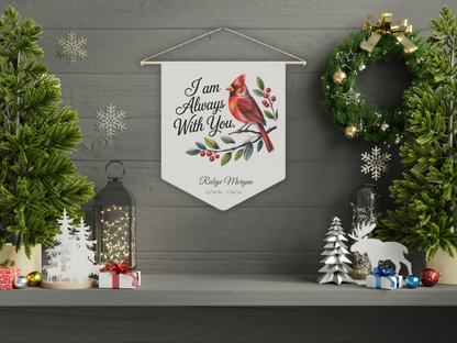 Decorative pennant flag with cardinal and text in a festive setting with wreath and lanterns.