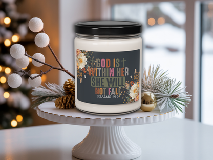 Candle jar with a motivational quote on a white surface with decorative elements.