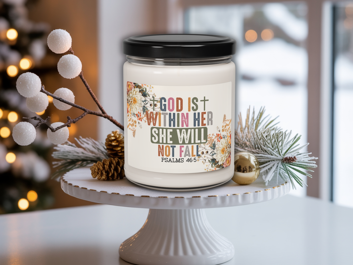 Candle jar with motivational quote on a decorative stand with Christmas decorations.