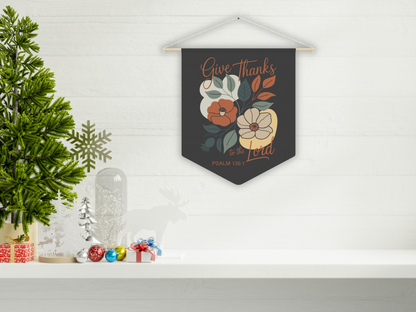 Decorative wall hanging with floral design and text on a white shelf with Christmas decorations.