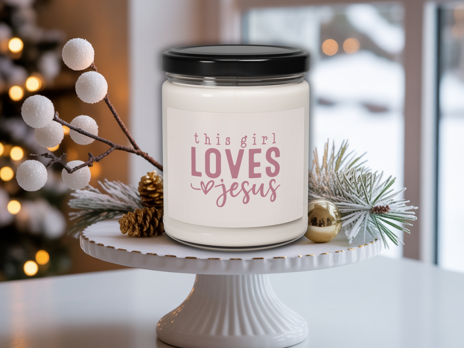Candle with 'this girl LOVES Jesus' text on a white stand with decorative elements.