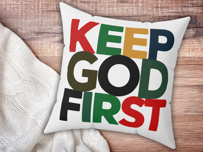 White pillow with colorful text 'KEEP GOD FIRST' on a wooden surface.