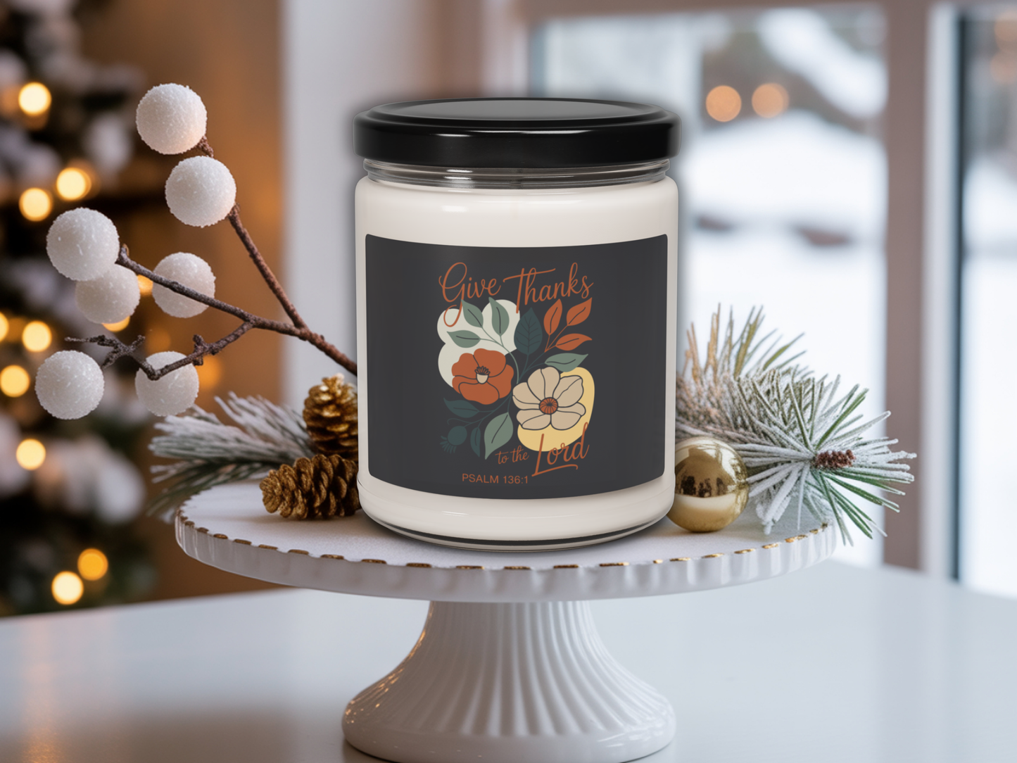 Candle with a 'Give Thanks' label on a white stand with decorative elements.