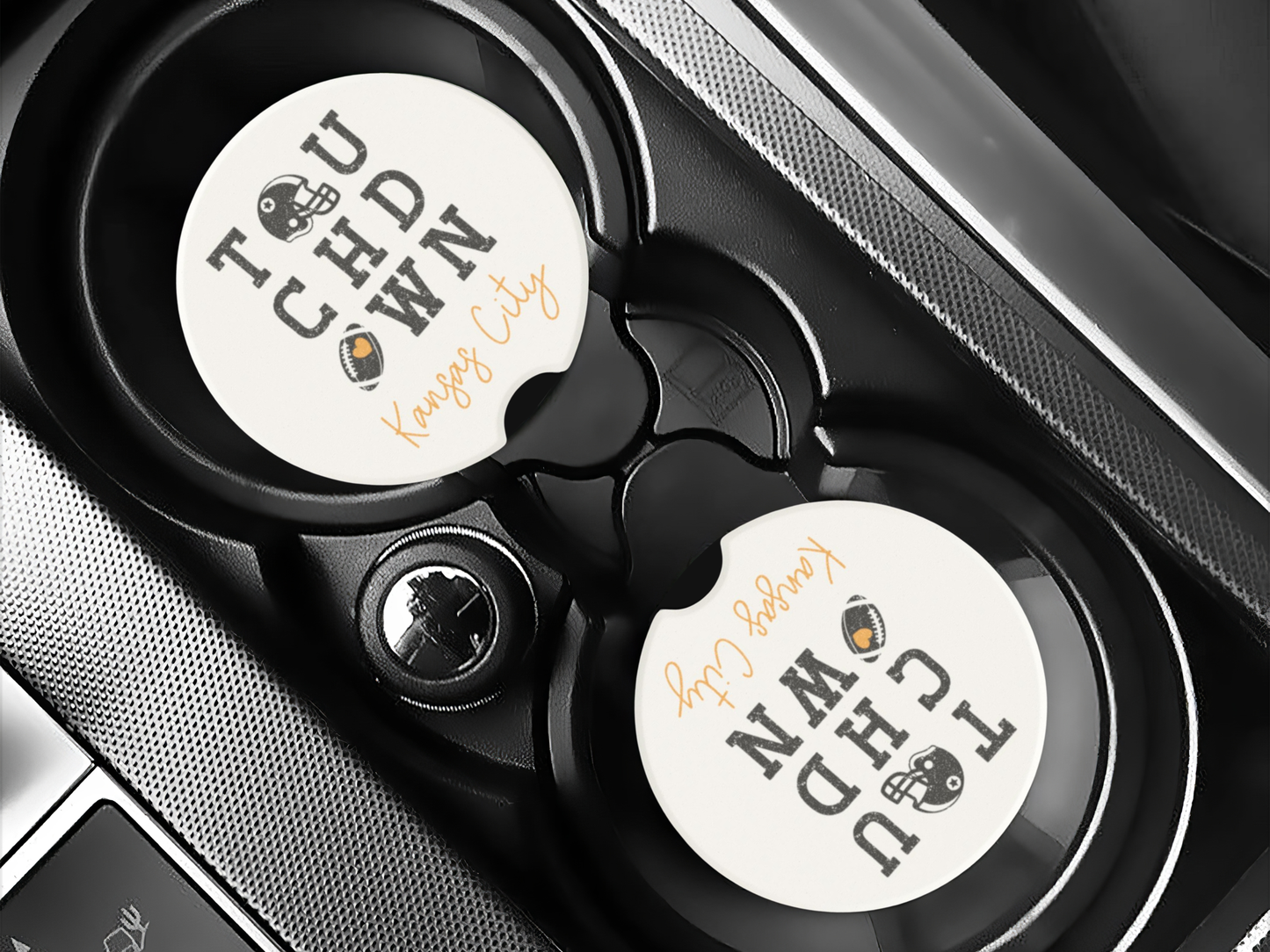 Two round coasters with text and graphics on a car cup holder