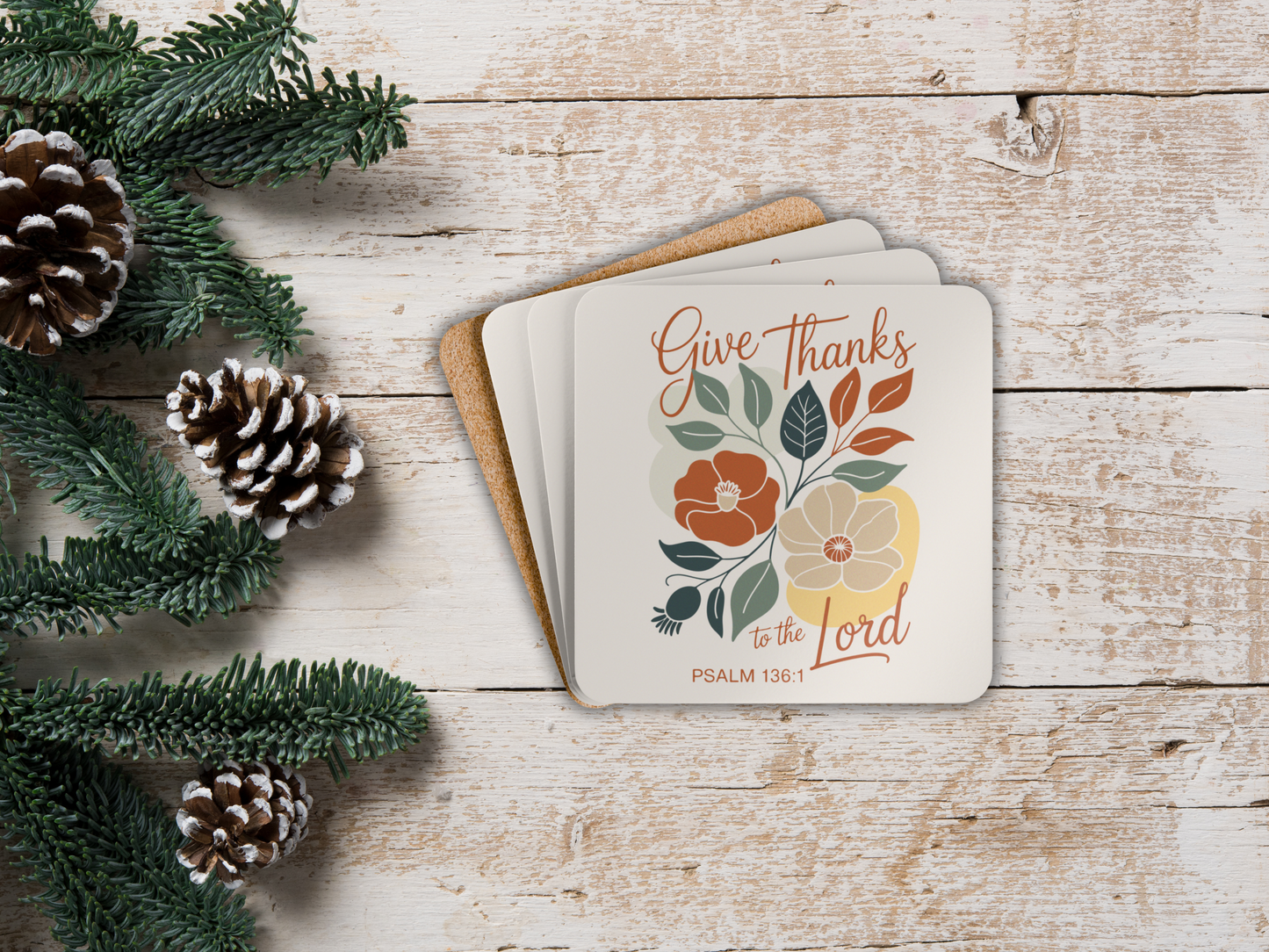 Coaster set  with 'Give Thanks to the Lord' text on a wooden surface with pinecones and greenery.