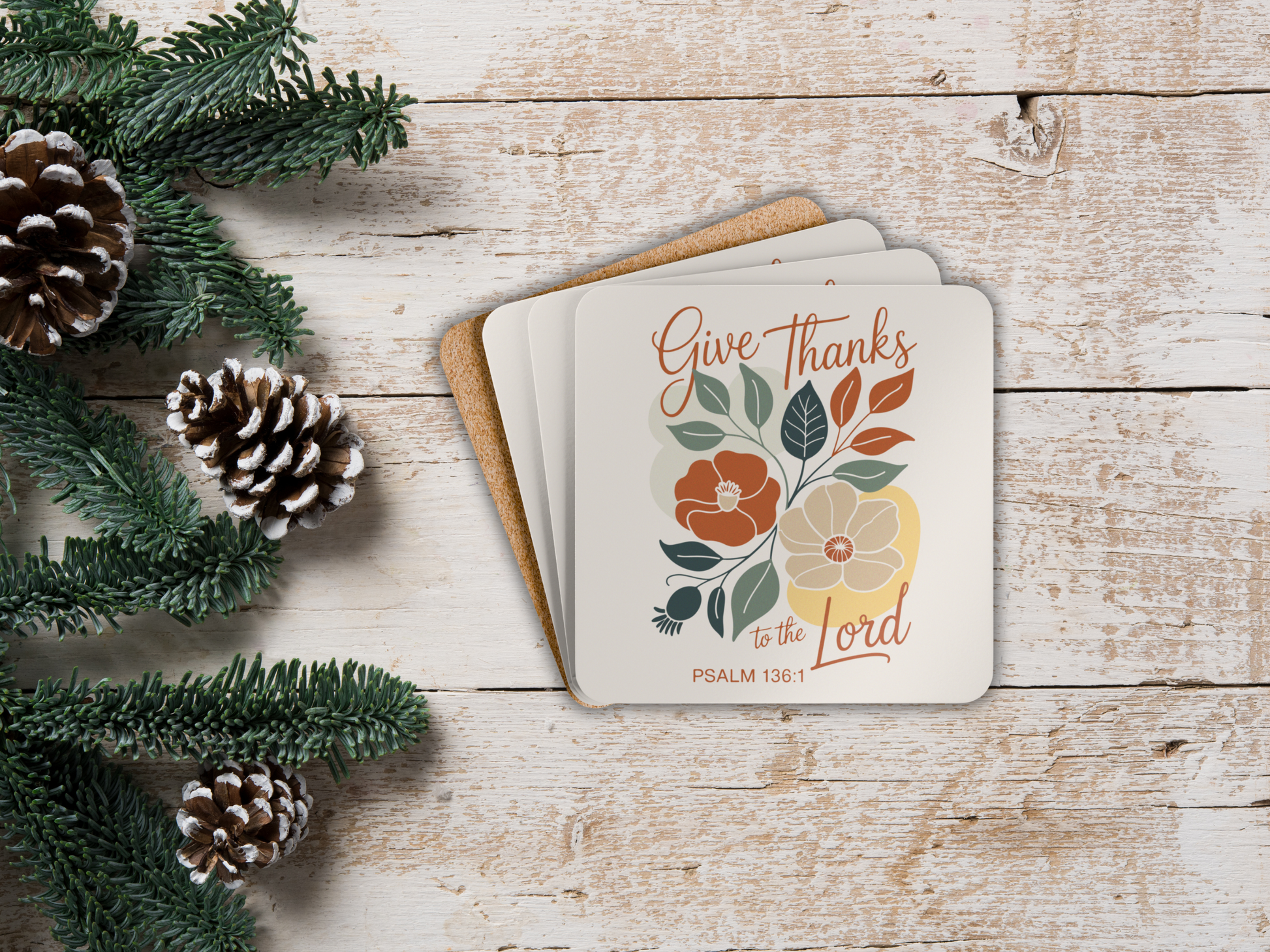 Coaster set  with 'Give Thanks to the Lord' text on a wooden surface with pinecones and greenery.