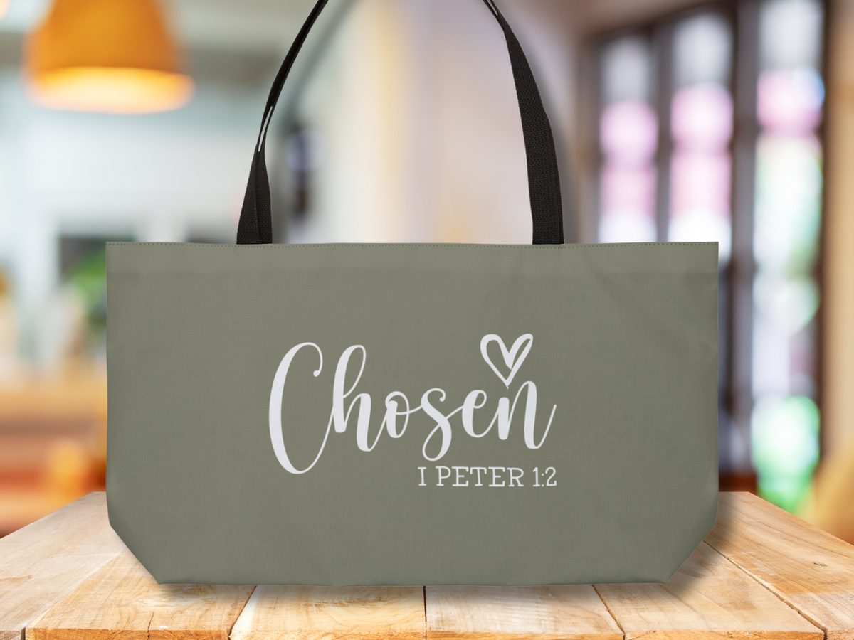 Scripture tote bag on wooden tabletop with warm indoor lighting and windows in the background.