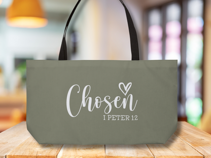 Scripture tote bag on wooden tabletop with warm indoor lighting and windows in the background.