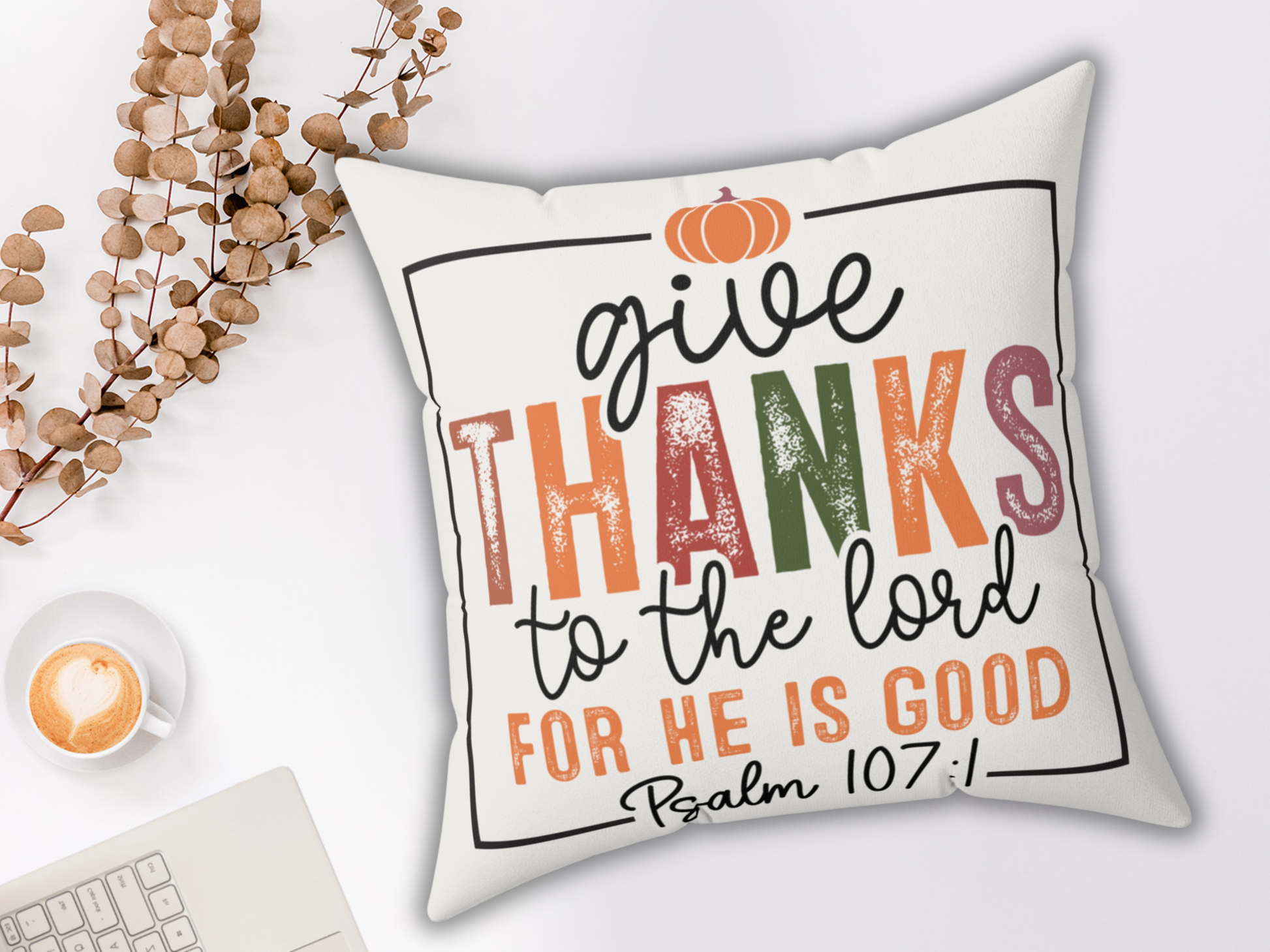 “Give Thanks” pillow with latte, laptop, and dried branches for a cozy workspace vibe.