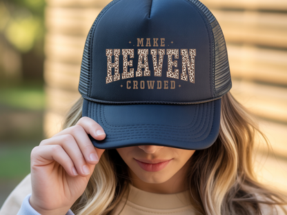 Person wearing a navy blue cap with 'MAKE HEAVEN CROWDED' text.