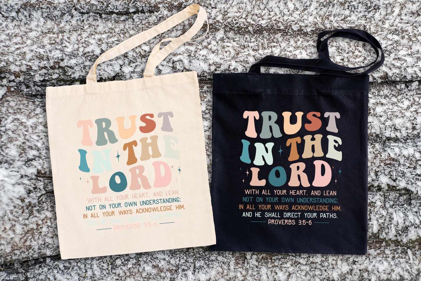 Two tote bags with 'Trust in the Lord' text on a textured surface