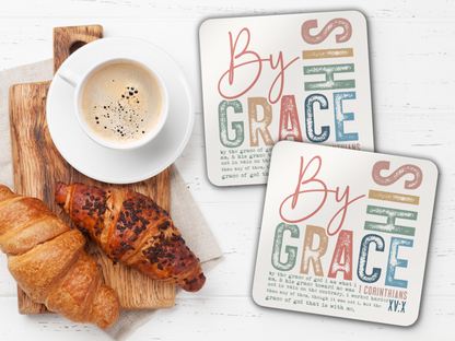 Pair of scripture coasters with coffee and croissants on wooden serving board over white table.