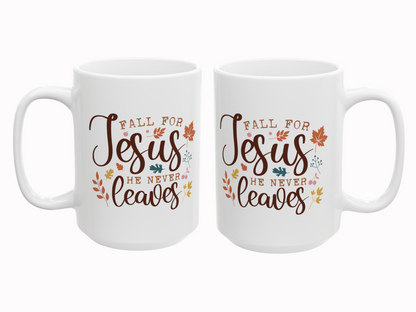 Two white mugs with 'Fall for Jesus he never leaves' text and leaf designs on a white background