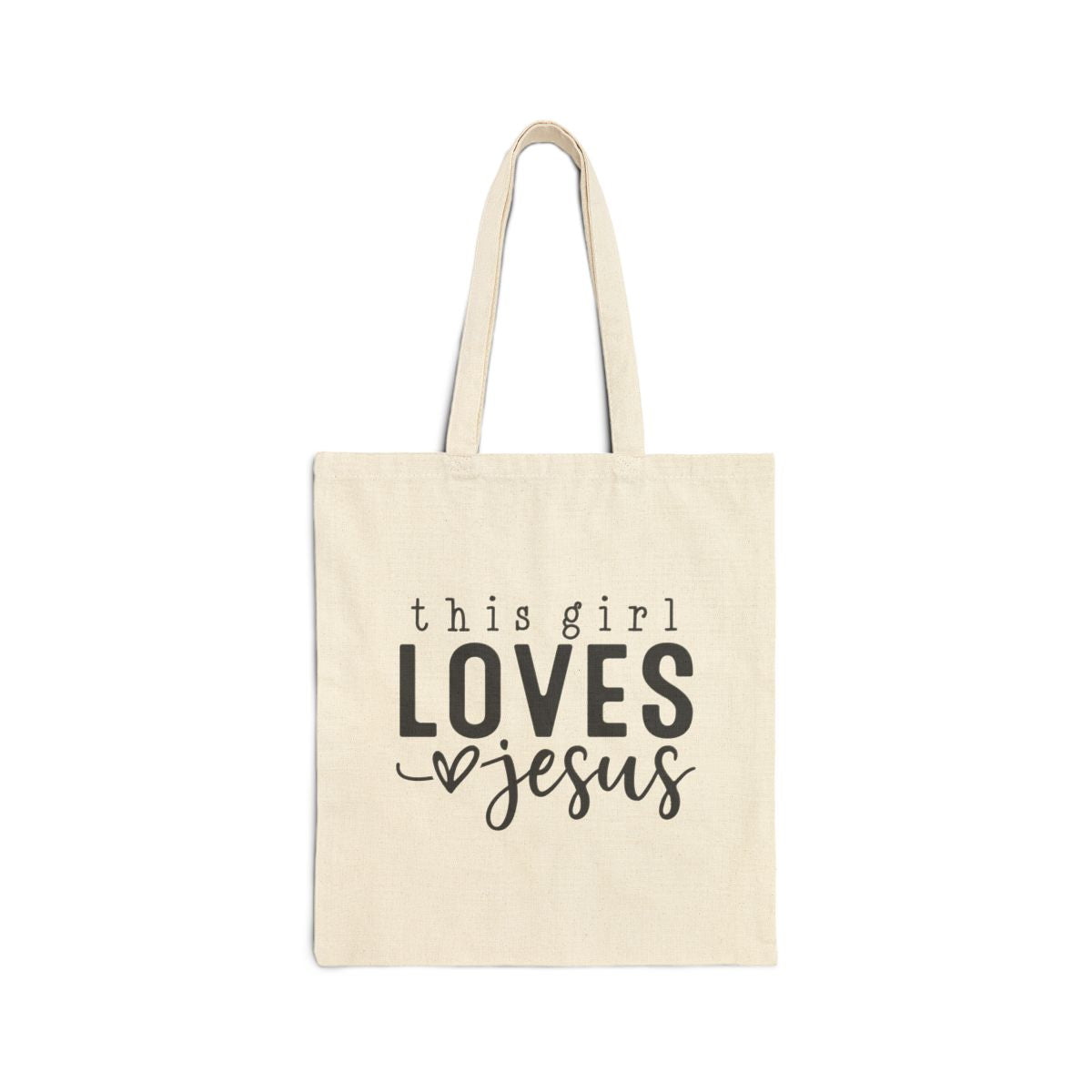 Beige tote bag with 'this girl LOVES Jesus' text on a white background