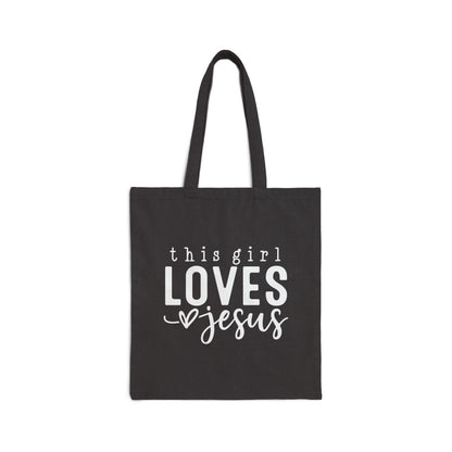 Black tote bag with 'this girl LOVES Jesus' text on a white background
