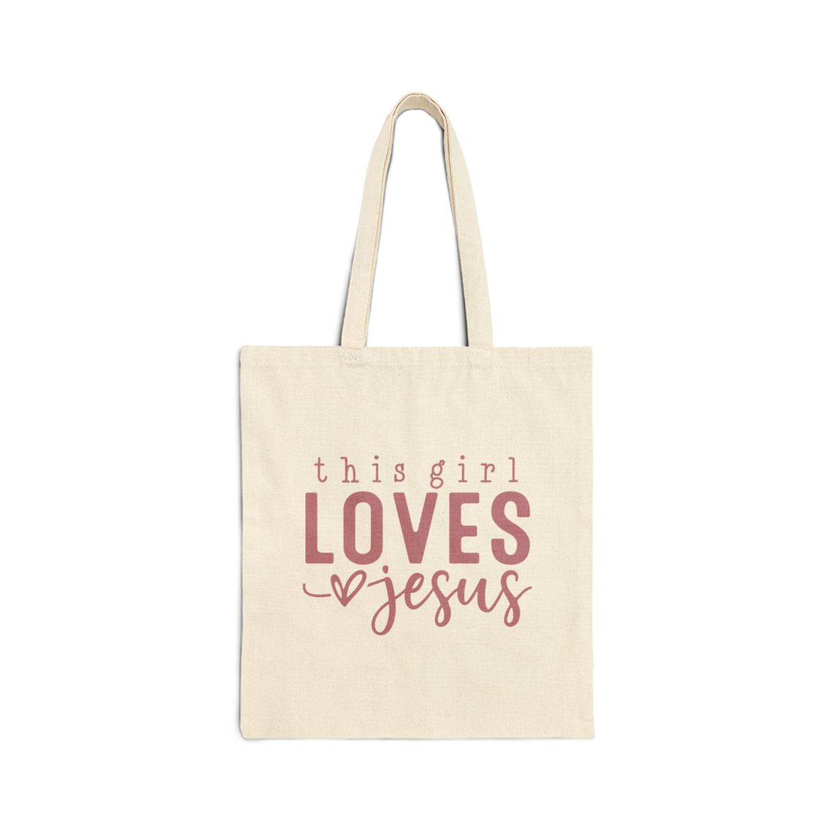 Beige tote bag with 'this girl LOVES Jesus' text on a white background