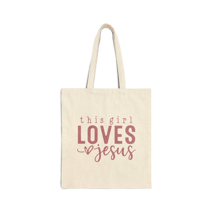Beige tote bag with 'this girl LOVES Jesus' text on a white background