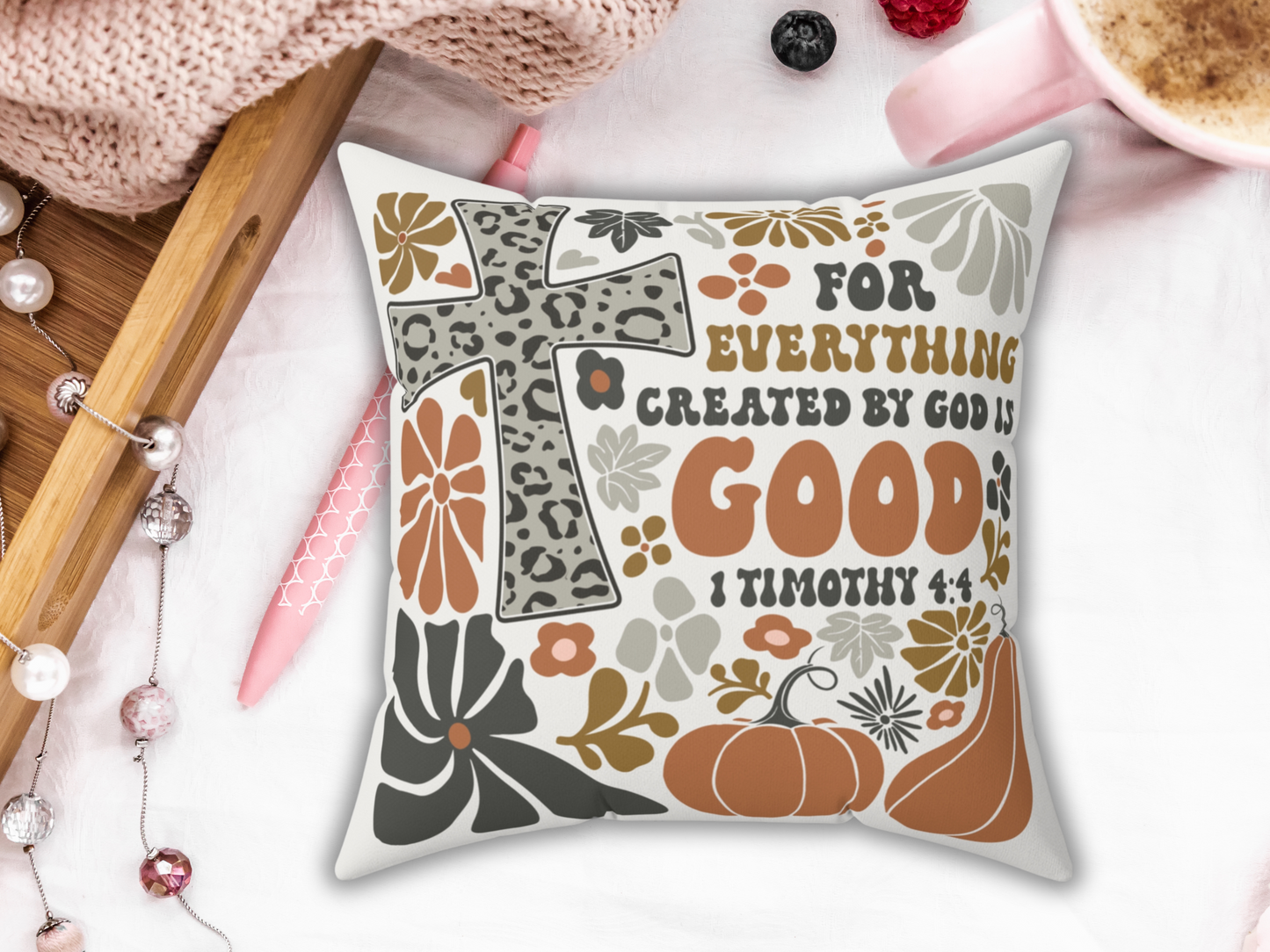 Fall scripture pillow with leopard print cross, pumpkins, and flowers reading “For everything created by God is good – 1 Timothy 4:4,” styled with tray, pen, and coffee.