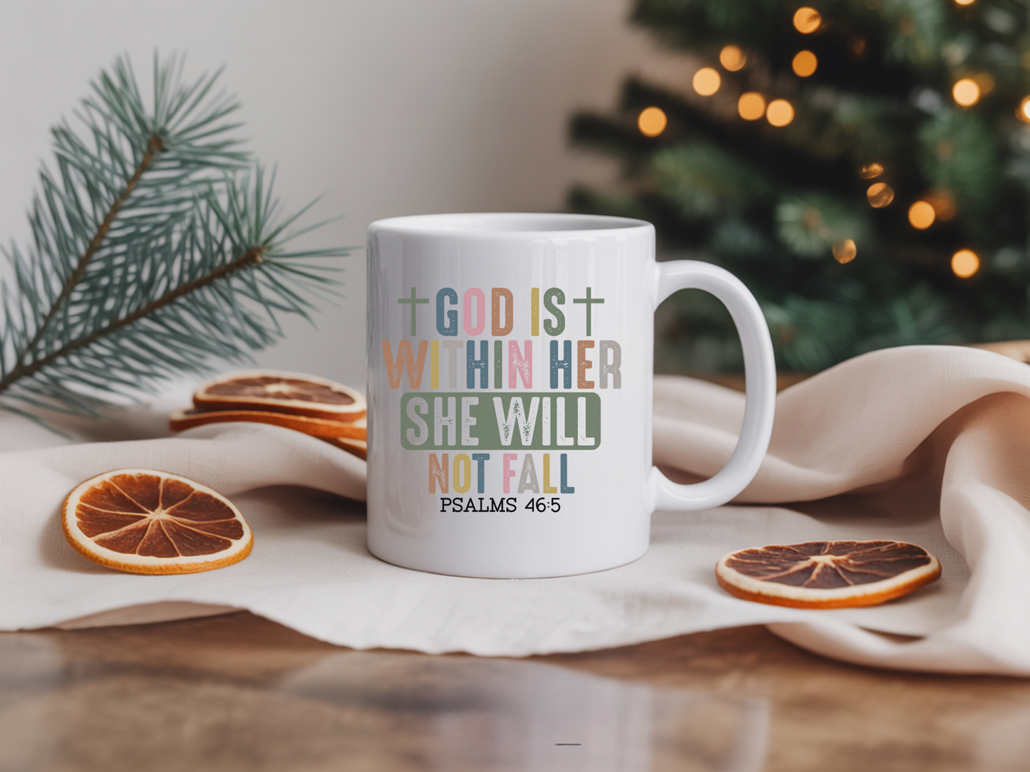 White mug with motivational quote on a table with Christmas decorations