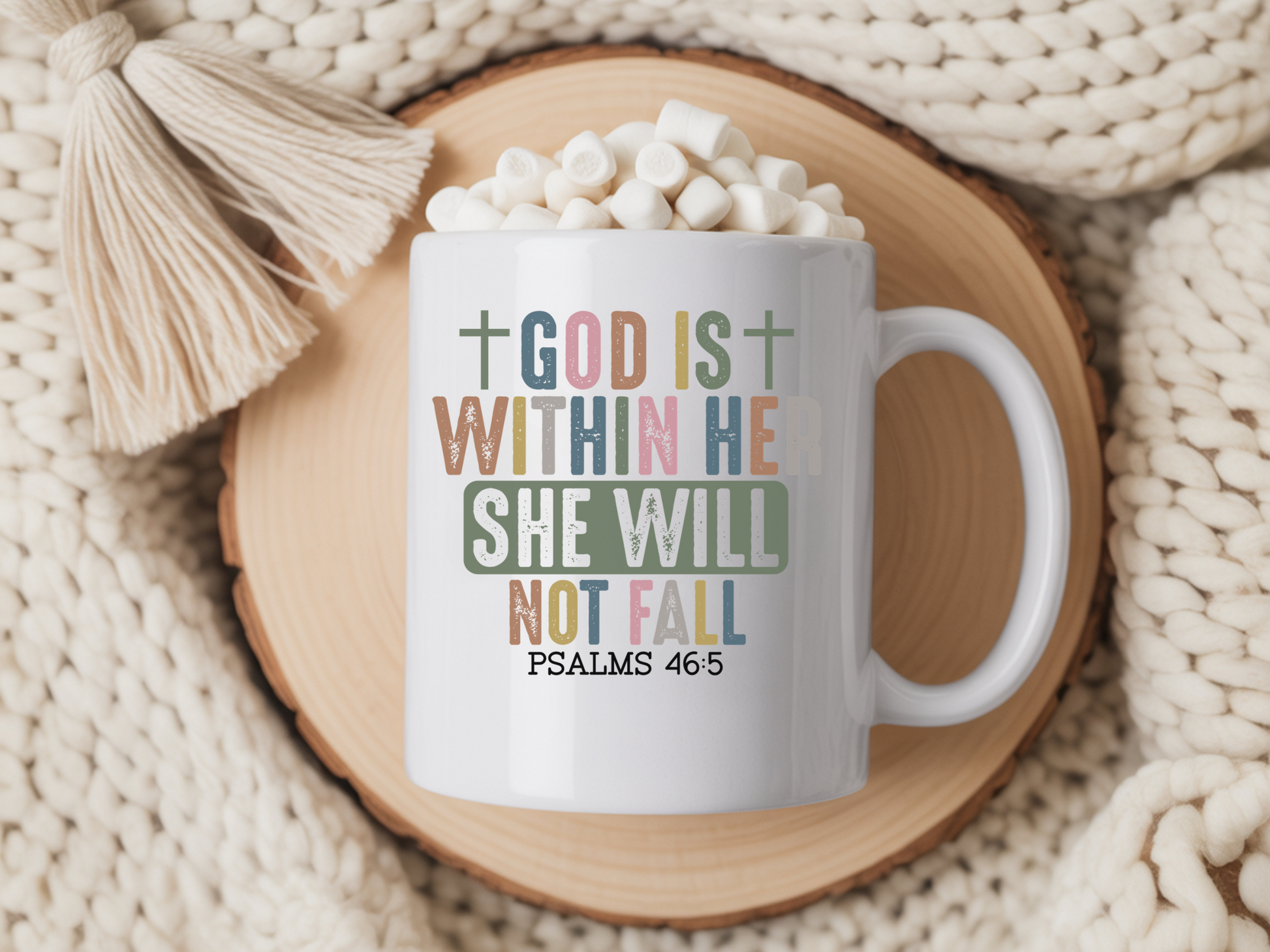 Mug with inspirational quote on a wooden coaster with hot chocolate and marshmallows.