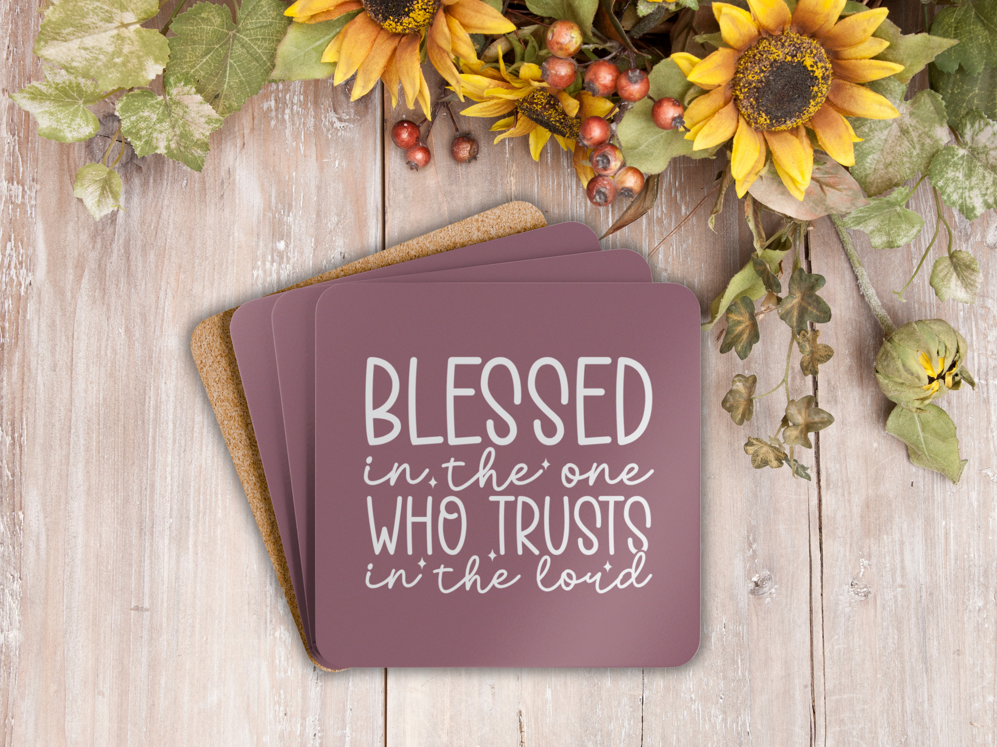 Coasters stacked on rustic wood with autumn florals and sunflowers, showing cork backing.